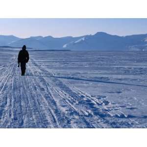  Local Walking Through Arctic Landscape Carrying Gun for 