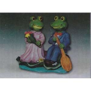   Frogs Boy / Girl with Paddle on a Lilly Pad Scene