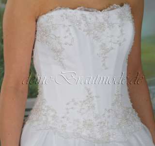 Das luxuriöse, einteilige Hochzeitskleid wird aus edlem Taft 