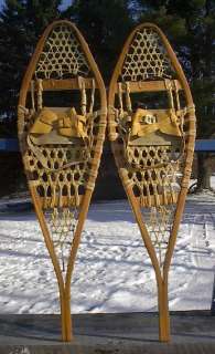 This auction is for a set of snowshoes that are made of wood frame and 