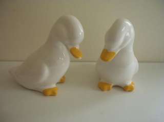 TWO WHITE CERAMIC DUCKLING ORNAMENTS  