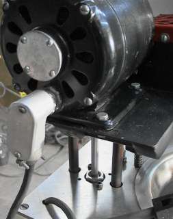 An air cylinder lifts the mix motor and lid assembly as shown here.