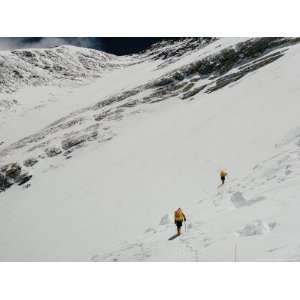 Two Mount Everest Expedition Members Climbing a Steep Mountain Slope 