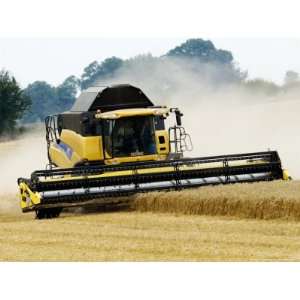 Yellow New Holland Combine Harvester Harvesting Wheat Field, UK 